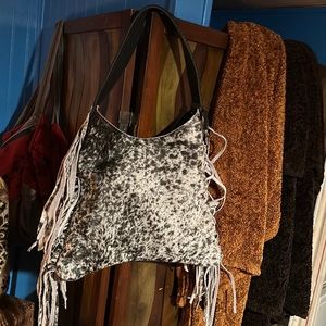 black and white real leather the fur is real insides has four pockets